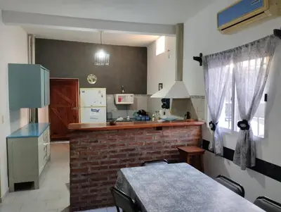 a kitchen with a counter and a brick wall at Azulina in Alta Gracia