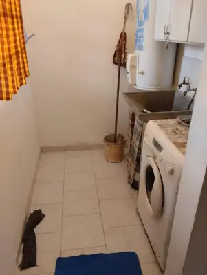a small kitchen with a washing machine in it at Azulina in Alta Gracia