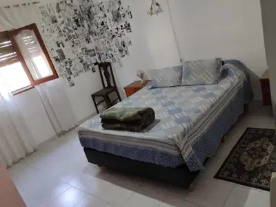 a bedroom with a bed with a pillow on it at Azulina in Alta Gracia