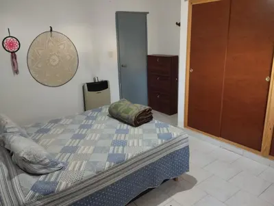 a bedroom with a bed and a dresser at Azulina in Alta Gracia