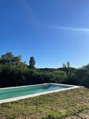 an empty swimming pool in the middle of a field at La Madruguera de Potrerillo in Alta Gracia