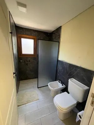 a bathroom with two toilets and a sink at La Madruguera de Potrerillo in Alta Gracia