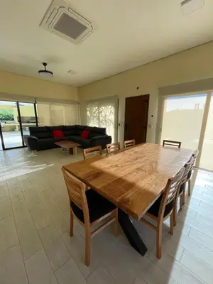 a living room with a wooden table and a couch at La Madruguera de Potrerillo in Alta Gracia