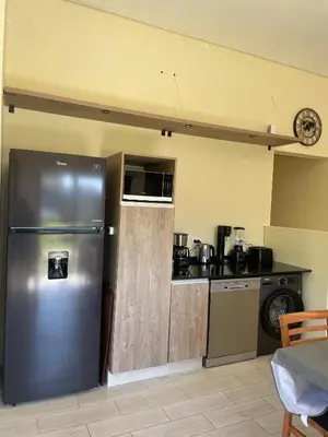 a kitchen with a stainless steel refrigerator in a room at La Madriguera de Potrerillo in Alta Gracia
