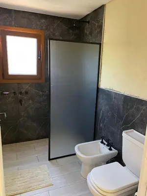 a bathroom with a toilet and a sink at La Madriguera de Potrerillo in Alta Gracia
