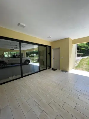 an empty house with a car in a garage at La Madriguera de Potrerillo in Alta Gracia