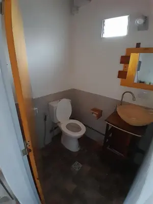 a small bathroom with a toilet and a sink at La Casita de Caeiro in Bialet Massé