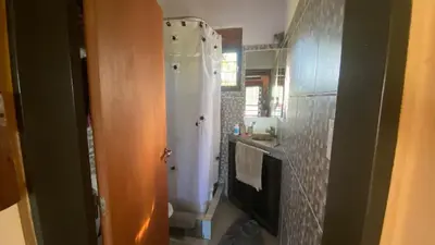 a bathroom with a white shower in a room at Flor Serrana in Cavalango