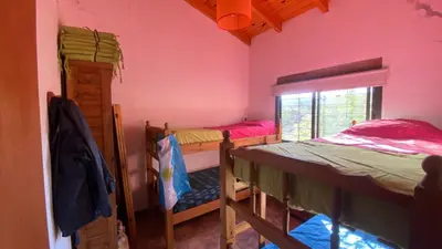 a room with two bunk beds and a window at Flor Serrana in Cavalango