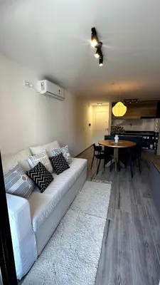 a living room with a couch and a dining room at Nva Cba, Calle Rondeau in Cordoba