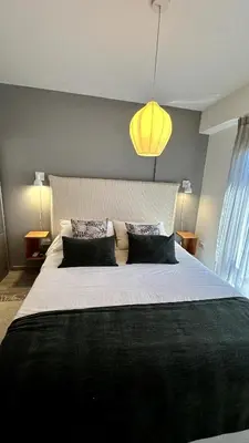 a bedroom with a large bed and a yellow light at Nva Cba, Calle Rondeau in Cordoba