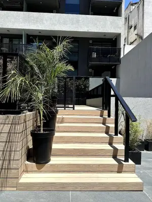 a staircase leading to a building with potted plants at Nva Cba, Calle Rondeau in Cordoba