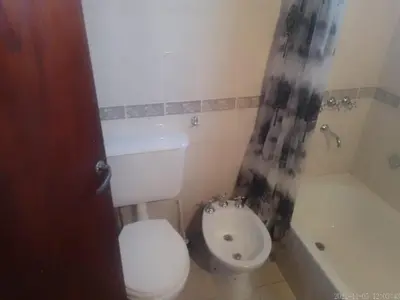 a bathroom with a toilet and a sink and a tub at Sierras y sol in Villa Cura Brochero