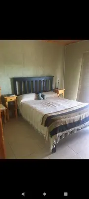 a bedroom with a large bed in a room at Cabaña Flor Serrana in Tanti