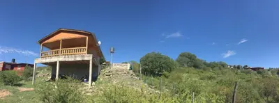 a building on the side of a hill at Cabaña Flor Serrana in Tanti