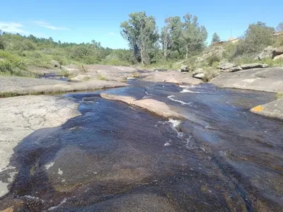 an image of a river with rocks and water at Cabaña Flor Serrana in Tanti