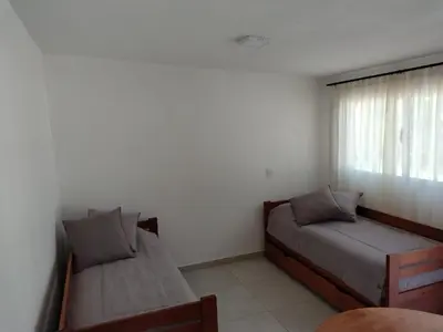 a bedroom with two beds and a window at Selene in Villa Rumipal