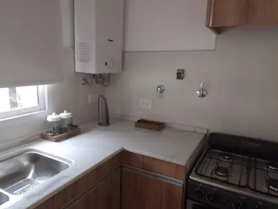 a kitchen with a sink and a stove at Selene in Villa Rumipal