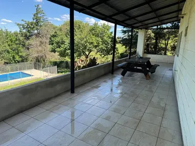 a patio with a bench and a view of a pool at Casa Villa Santa Cruz del Lago in Villa Santa Cruz del Lago