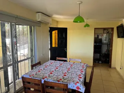 a dining room with a table with a flowered table cloth at Casa Villa Santa Cruz del Lago in Villa Santa Cruz del Lago