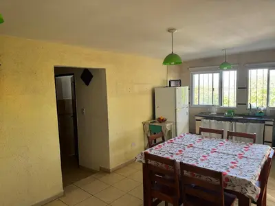 a kitchen with a table and a kitchen with a refrigerator at Casa Villa Santa Cruz del Lago in Villa Santa Cruz del Lago