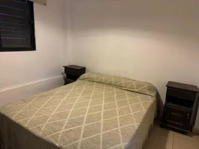 a small bedroom with a bed and two night stands at Casa Villa Santa Cruz del Lago in Villa Santa Cruz del Lago