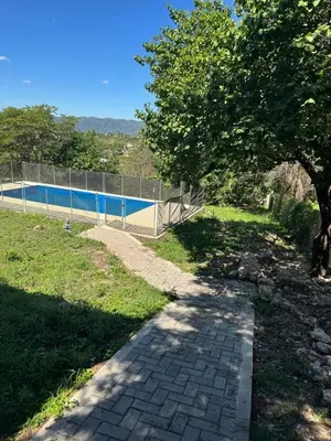 a brick path leading to a swimming pool at Casa Villa Santa Cruz del Lago in Villa Santa Cruz del Lago