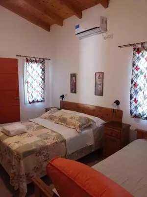 a bedroom with two beds and a window at La Nueva in Villa Ciudad Parque