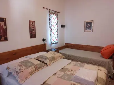 a bedroom with two beds and a window at La Nueva in Villa Ciudad Parque