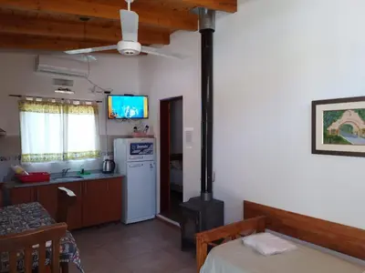 a kitchen and living room with a stove at La Nueva in Villa Ciudad Parque