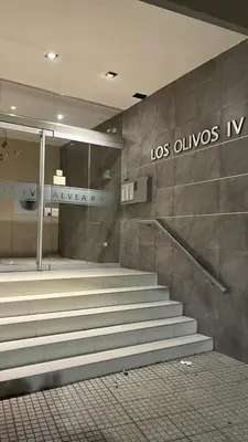 an empty lobby with stairs in a building at Departamento Orlando, zona centro in Villa Carlos Paz