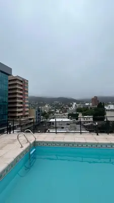 a swimming pool on the roof of a building at Departamento Orlando, zona centro in Villa Carlos Paz