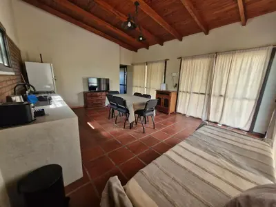 a large room with a table and chairs in it at Casa Runa Kay in Almafuerte