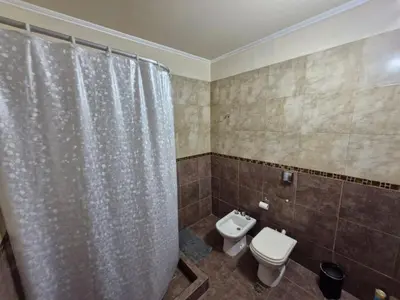 a bathroom with a toilet and a shower curtain at Casa Runa Kay in Almafuerte