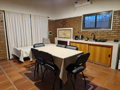 a kitchen with a table and chairs in a room at Casa Runa Kay in Almafuerte