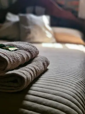 a pile of towels sitting on top of a bed at Casa Runa Kay in Almafuerte