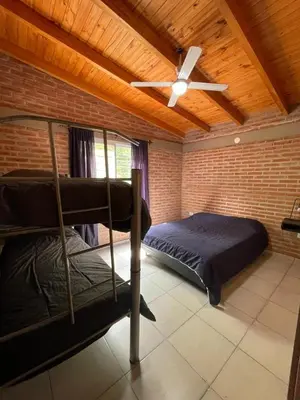 a bedroom with two bunk beds and a ceiling fan at Cabañas Nuevos Elefantes in Villa Cura Brochero