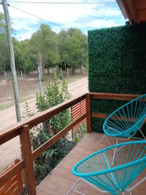 a blue chair sitting on a wooden deck at Depto Cabañero Lumai in Villa Ciudad Parque