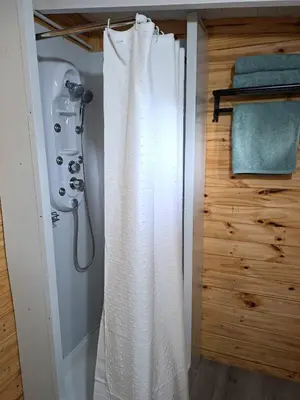 a shower in a bathroom with a shower curtain at Depto Cabañero Lumai in Villa Ciudad Parque