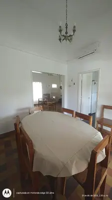 a dining room with a large table and chairs at Casa Amarilla in Santa Rosa de Calamuchita