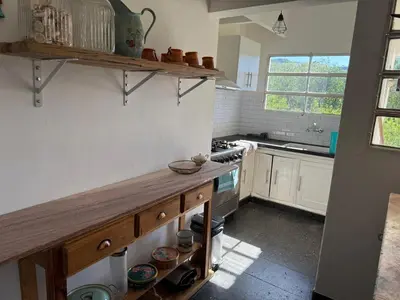 a kitchen with a wooden counter in a room at Casa Amarilla in Santa Rosa de Calamuchita