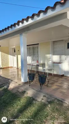 a patio of a house with a table and chairs at Casa Amarilla in Santa Rosa de Calamuchita