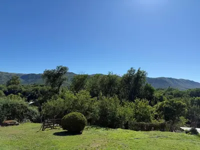 a view of a field with mountains in the background at Casa Amarilla in Santa Rosa de Calamuchita