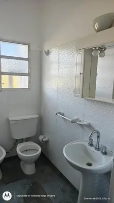 a white bathroom with a toilet and a sink at Casa Amarilla in Santa Rosa de Calamuchita