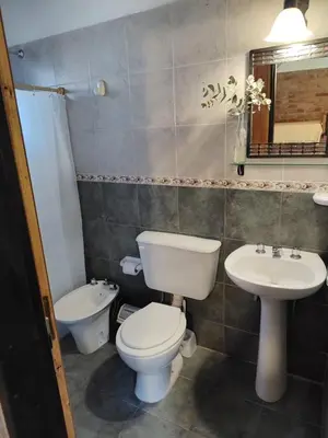 a bathroom with a toilet and a sink at Cabañas del IntiCo in Arroyo de Los Patos