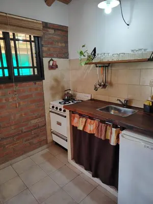 a kitchen with a sink and a stove at Cabañas del IntiCo in Arroyo de Los Patos