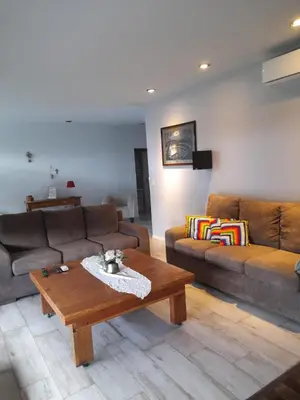 a living room with two couches and a coffee table at Casa con encanto serrano in Villa General Belgrano