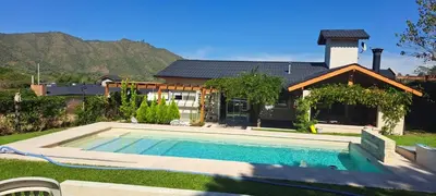 a house with a swimming pool in the yard at Casa con encanto serrano in Villa General Belgrano