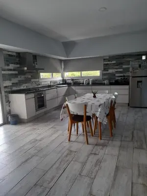 a kitchen with a table and chairs in a room at Casa con encanto serrano in Villa General Belgrano