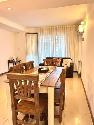 a dining room with a wooden table and chairs at Apartamento Carde Housing in Villa Carlos Paz